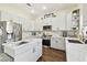 Kitchen featuring white cabinets, an island with stone countertops and stainless appliances at 13310 Waterford Run Dr, Riverview, FL 33569