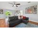 Comfortable living room with hardwood floors, sofa, and access to the balcony at 13310 Waterford Run Dr, Riverview, FL 33569