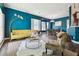 Bright living room with a golden sofa, large rug, and natural light at 13310 Waterford Run Dr, Riverview, FL 33569