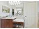 Bright bathroom vanity with marble-look countertop and lots of mirror space; features elegant fixtures and hardware at 13310 Waterford Run Dr, Riverview, FL 33569