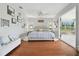 Bright main bedroom features hardwood floors, ceiling fan, sitting area, and sliding door to screened porch at 13310 Waterford Run Dr, Riverview, FL 33569