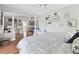Bright main bedroom has wood floors, a ceiling fan, accent wall decor, and an attached office or seating area at 13310 Waterford Run Dr, Riverview, FL 33569