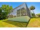 Enclosed screened patio on a two-story home featuring an outdoor seating area on the ground floor at 13310 Waterford Run Dr, Riverview, FL 33569