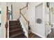 Elegant staircase featuring dark wood steps, white risers, and wood railing at 13310 Waterford Run Dr, Riverview, FL 33569