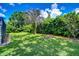 Expansive backyard with lush greenery and space to relax or entertain at 14119 Stonegate Dr, Tampa, FL 33624