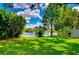 Lush backyard featuring tranquil water view and mature trees at 14119 Stonegate Dr, Tampa, FL 33624