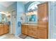 Bright bathroom with double sinks, vanity with storage, and a large mirror at 14119 Stonegate Dr, Tampa, FL 33624