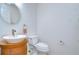 Simple bathroom features a modern sink on a wood cabinet and a toilet at 14119 Stonegate Dr, Tampa, FL 33624