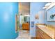 Bright bathroom featuring tile floors, double sinks, vanity with storage and a mirror at 14119 Stonegate Dr, Tampa, FL 33624
