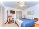 Bright bedroom featuring a ceiling fan, TV, rocking chair, and a cozy blue quilt at 14119 Stonegate Dr, Tampa, FL 33624
