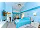 Blue bedroom with a ceiling fan and large window with blinds and decor at 14119 Stonegate Dr, Tampa, FL 33624