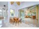 Dining area with windows and sliding glass doors that lead to the sunroom and views of the outdoors at 14119 Stonegate Dr, Tampa, FL 33624