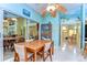 Dining room with wood table, chairs, and natural light near a glass-enclosed patio at 14119 Stonegate Dr, Tampa, FL 33624