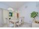 Elegant dining room featuring a chandelier, table with seating for six, and large window at 14119 Stonegate Dr, Tampa, FL 33624