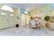 Elegant dining room with marble floors, chandelier, and a dining set for six, bathed in natural light at 14119 Stonegate Dr, Tampa, FL 33624