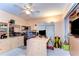 Bright home office featuring a ceiling fan, built-in shelves and cabinets, plus a spacious desk with an ergonomic chair at 14119 Stonegate Dr, Tampa, FL 33624