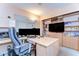 This home office boasts built-in shelves, cabinets, a large desk, and a comfortable chair, perfect for remote work at 14119 Stonegate Dr, Tampa, FL 33624