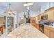 Bright kitchen with stainless appliances, granite countertops, and a central island with barstool seating at 14119 Stonegate Dr, Tampa, FL 33624