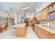 Bright kitchen with ample wood cabinets, a large island, and high ceilings at 14119 Stonegate Dr, Tampa, FL 33624