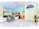 Open-concept living room featuring marble floors, high ceilings, large windows, and a seamless flow to other areas at 14119 Stonegate Dr, Tampa, FL 33624