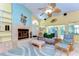Bright living room with vaulted ceilings, fireplace, tile flooring, and access to the outdoor pool area at 14119 Stonegate Dr, Tampa, FL 33624