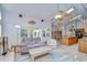 Relaxing living room with a ceiling fan, natural light, and cozy furniture at 14119 Stonegate Dr, Tampa, FL 33624