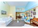 Bright living room with high ceilings, piano, sofa, and access to backyard patio at 14119 Stonegate Dr, Tampa, FL 33624