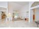 Bright living room with vaulted ceilings, marble floors, and open access to other rooms at 14119 Stonegate Dr, Tampa, FL 33624