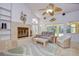 Comfortable living room featuring a fireplace, ceiling fan, and access to the pool area at 14119 Stonegate Dr, Tampa, FL 33624