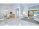 Open concept design features living, dining, and Gathering spaces with travertine flooring at 14119 Stonegate Dr, Tampa, FL 33624