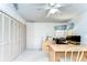 Home office with desk, ceiling fan, built-in closet and drawer space, and a light yellow color scheme at 14119 Stonegate Dr, Tampa, FL 33624