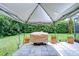 Outdoor grill area with a grill cover under a canvas pergola in the backyard at 14119 Stonegate Dr, Tampa, FL 33624