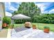Outdoor grill and dining area under the backyard pergola, with plenty of space to entertain at 14119 Stonegate Dr, Tampa, FL 33624