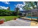 Relaxing screened in lanai and patio in a landscaped backyard at 14119 Stonegate Dr, Tampa, FL 33624