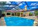 A stunning screened-in pool area with plenty of room for entertaining and relaxing at 14119 Stonegate Dr, Tampa, FL 33624