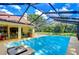 Screened-in pool area featuring a sparkling pool, patio space, and serene backyard views at 14119 Stonegate Dr, Tampa, FL 33624