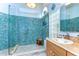 A lavish walk-in shower showcasing eye-catching blue tiles and multiple shower heads at 14119 Stonegate Dr, Tampa, FL 33624