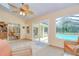 Bright sun room with tile floors, large windows, and outdoor access at 14119 Stonegate Dr, Tampa, FL 33624