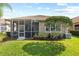Landscaped backyard featuring a screened-in patio and lush green lawn at 14521 Mirasol Manor Ct, Tampa, FL 33626