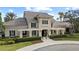 Inviting clubhouse entrance with elegant architecture, covered pergola, and manicured landscaping at 14521 Mirasol Manor Ct, Tampa, FL 33626