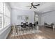 Open concept dining room with hardwood floors, modern lighting, and neutral paint at 14521 Mirasol Manor Ct, Tampa, FL 33626