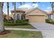 Charming home with a tile roof, manicured landscaping, and a two-car garage at 14521 Mirasol Manor Ct, Tampa, FL 33626