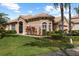 Well-maintained home with lush landscaping and a tile roof at 14521 Mirasol Manor Ct, Tampa, FL 33626