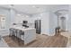 Modern kitchen featuring white cabinets, stainless steel appliances, and a spacious island with quartz countertops and seating at 14521 Mirasol Manor Ct, Tampa, FL 33626