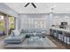 Inviting living space featuring a plush sofa, glass coffee table, and views of the modern kitchen at 14521 Mirasol Manor Ct, Tampa, FL 33626