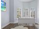 Bright office with arch windows, plantation shutters, white desk, and wood floors at 14521 Mirasol Manor Ct, Tampa, FL 33626