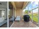 The covered brick patio includes comfortable seating and a grill at 14521 Mirasol Manor Ct, Tampa, FL 33626