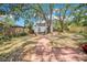 A backyard featuring mature trees, a storage shed, and a brick path at 150 23Rd N Ave, St Petersburg, FL 33704