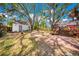 Lush backyard boasts a brick patio, mature trees, privacy fence, and an additional storage shed for outdoor enjoyment at 150 23Rd N Ave, St Petersburg, FL 33704