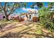 Quaint backyard featuring a brick pathway, mature trees, and a private wooden deck at 150 23Rd N Ave, St Petersburg, FL 33704